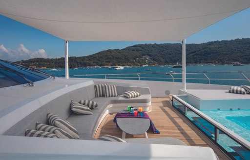 Pool and seating area on luxury yacht MA, with sofas and shaded area