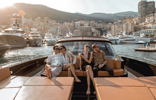 Two attractive couples aboard a private tender at the Monaco Yacht Show