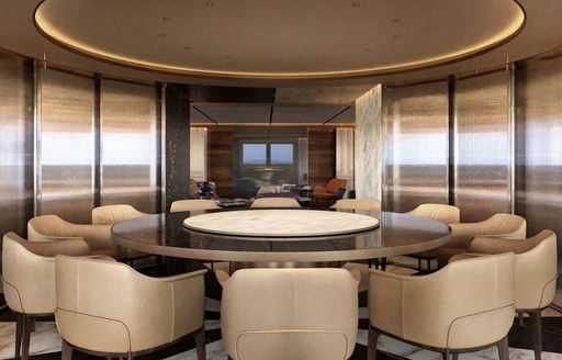 Interior dining set up with large round table and cream seating onboard superyacht charter RAJA