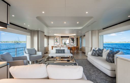 Main salon onboard charter yacht CARPE DIEM with extensive lounge area with plush white seating