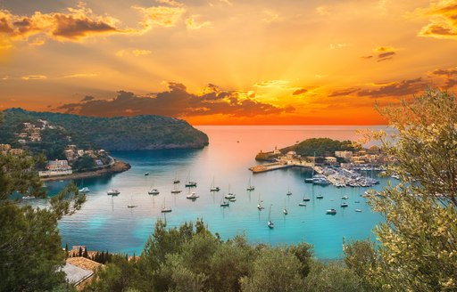 Ibiza harbor with anchored yachts at sunset