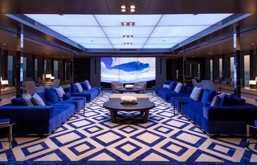 Main salon with blue seating onboard charter yacht BOLD