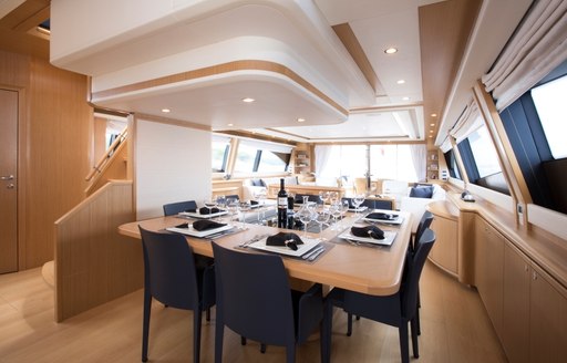 table prepared for dinner in the main salon of superyacht Porthos Sans Abri 