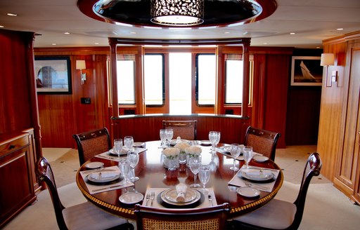 circular dining table in the dining salon aboard luxury yacht M4