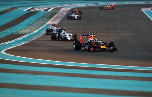 Cars rounding corner of Yas Marina race circuit