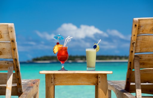 cocktails in the bahamas, tropical fruit drinks overlooking blue sea 