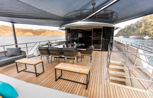 Exteriors with dining area and steps onboard charter yacht ZEEMAR