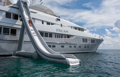 Slide on board luxury yacht DREAM with profile shot of charter yacht in background