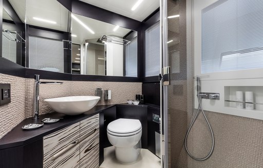 Sink, toilet and shower on motor yacht BEYOND, and mirrors behind