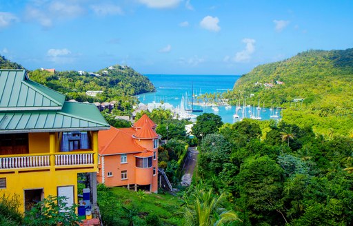 Elevated view of a Caribbean coastline with colored buildings in foreground