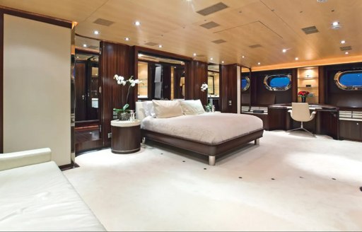 Master cabin onboard Parsifal III, central berth overlooks spacious cabin with vanity desk in background