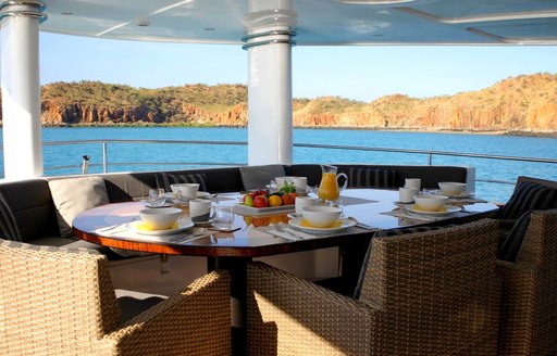 Alfresco dining table on the aft deck of superyacht Anda