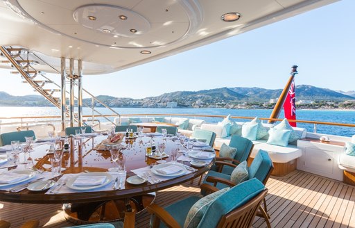 sophisticated alfresco dining setup on upper deck aft of charter yacht CALLISTO 