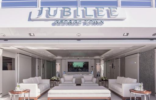 chic beach club aboard luxury yacht JUBILEE with sumptuous seating and aquarium