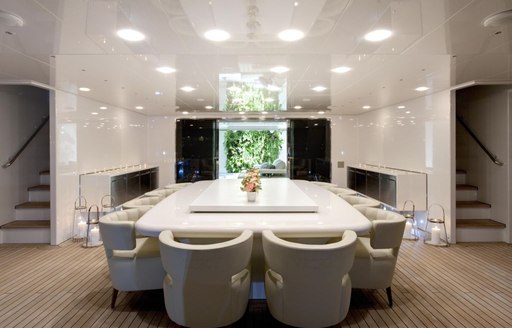 A fresh white dining table on the exterior of superyacht VICKY