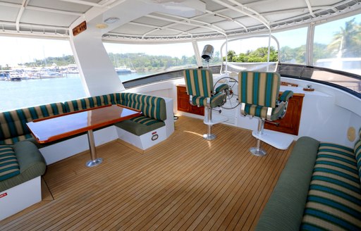 seating and table on flybridge of luxury yacht BAHAMA 