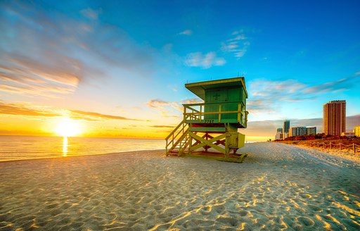 A lone lifeguard station on a beach in the USA at sunrise