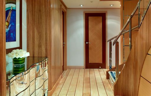 Wooden panelled corridor on Victoria Del Mar with staircase visible