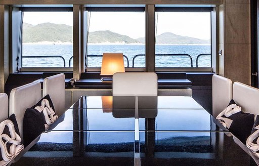 Dining table and window in background on motor yacht Oksanchik