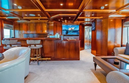 Private yacht charter LEVERAGE interior seating area with wet bar and stools