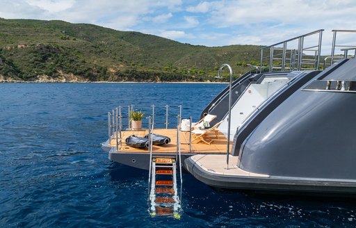 Swim platform and ladder leading into water onboard charter yacht M