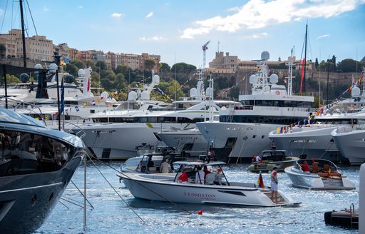 Superyachts berthed in Port Hercule and tender cruising