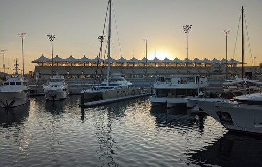 A fleet of motor yacht berthed at yas marina docks on the evening of the first day of Abu Dhabi Grand Prix 2019