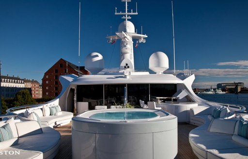 Jacuzzi surrounded by comfortable seating on sun deck of luxury yacht Odessa II