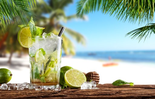 A close up of a cocktail on a tropical beach in the Bahamas