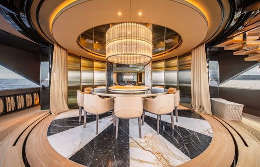Charter yacht RAJA² interior circular dining table