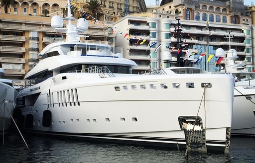 The profile of a white luxury yacht berthed in Monaco