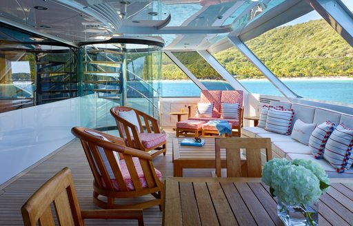 private terrace which adjoins master suite with huge windows and seating on board charter yacht ‘Victoria del Mar’ 