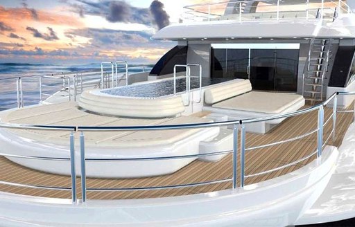 A large swimming pool surrounded by sunpads on the upper deck of a superyacht