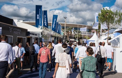 Visitors to the Cannes Yachting Festival walking between exhibitors