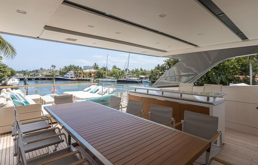 the large alfresco dining arangement on charter yacht freddy's flybridge