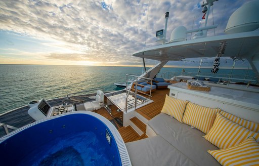 Deck Jacuzzi and exterior seating on deck of luxury yacht charter REHAB