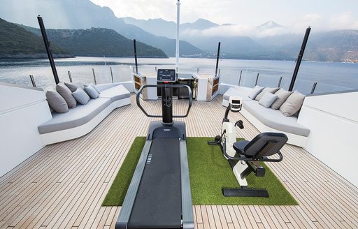 Charter yacht OURANOS gym equipment on astro turf on deck