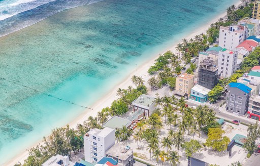 Male City, Maldives. Maldivian capital and local island from above. Hulhumale island with houses and coral reef