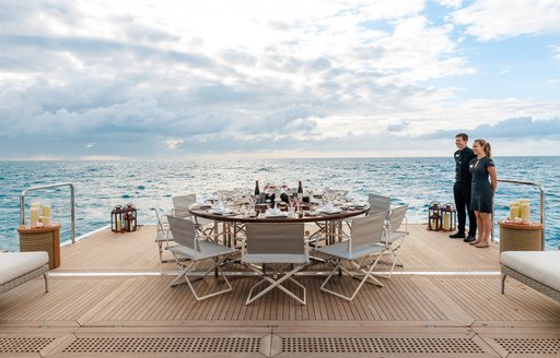 An alfresco circular dining table on the swim platform of charter yacht STARBURST IV