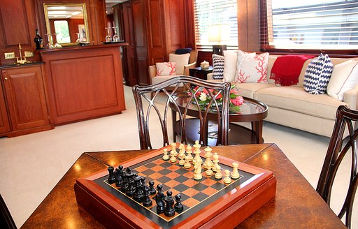 the interior games room with prepared chess set inside luxury superyacht Lady J