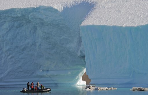 charter guests explore the dramatic snowy landscape of Antarctica bytender