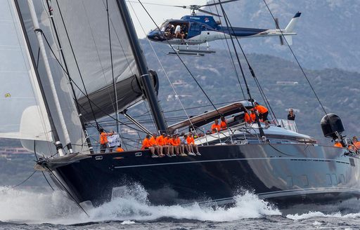 helicopter flies above charter yacht PERSEUS^3 as she competes in the Perini Navi Cup 