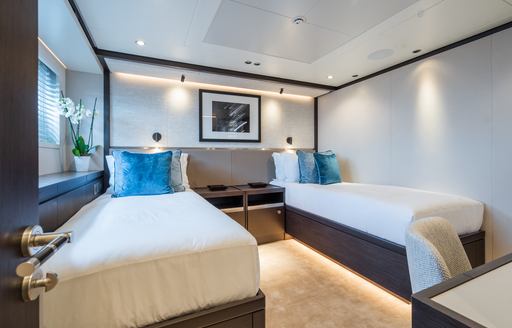 Twin cabin with two single berths facing forward onboard superyacht charter EMERALD