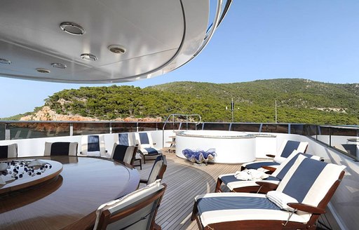 deck chairs, Jacuzzi and dining table on sundeck of luxury yacht ‘Ionian Princess’