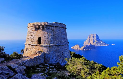 Turret in the mountains in Spanish island of Ibiza, looking out over Es Vedra rock