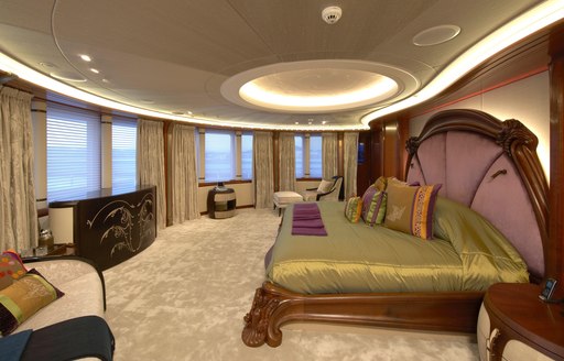 main suite on luxury superyacht with bed in centre