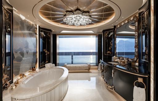 Ensuite facility with large bath tub and black sink unit onboard charter yacht KISMET