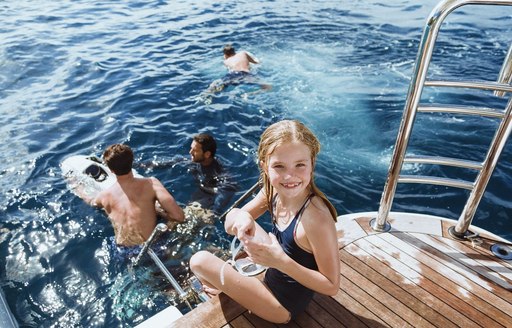 Girl sitting on Ramble on Rose swim platform