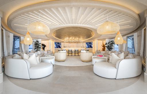 Interior seating area with plush white seating onboard charter yacht KISMET