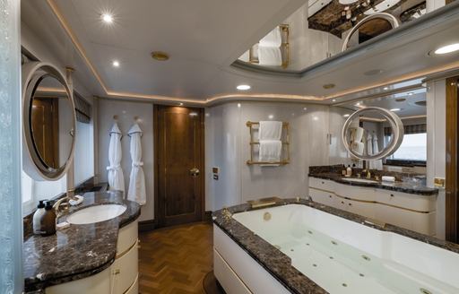En suite facility with marble sink unit and bath onboard charter yacht OLYMPUS